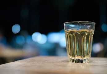 Hot Thai tea and roti drinks at a night shop with lights and bokeh.