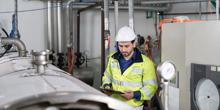 Engineers or factory managers wearing safety helmet inspect the machines in the production line. Utility inspector check machine and test the system to meet the standard. machine, maintenance.