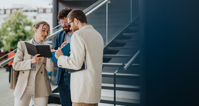 Group of professionals discussing work during an outdoor team meeting on stairs