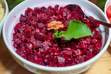Baked beetroot salad with cilantro in bowl. Healthy vegan food concept.