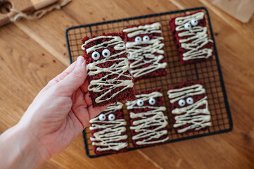 Halloween chocolate biscuits with googly eyes, funny spooky treats