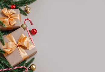 Festive New Year backdrop with gift boxes, fir branches, and ornaments, copy space