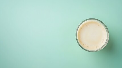Creamy Beverage in Glass on Mint Green Background for Refreshing Drink Inspiration and Food Photography