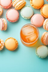 Obraz premium Colorful Macarons and Refreshing Drink on Turquoise Background Perfect for Dessert Lovers and Food Enthusiasts