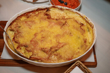 Moussaka is a Balkan oven dish. Potatoes, minced pork, fried onions in layers. 