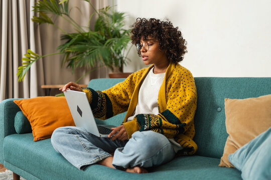 African American girl using laptop at home office typing chatting reading writing email. Young black woman having virtual meeting online chat video call conference. Work learning from home