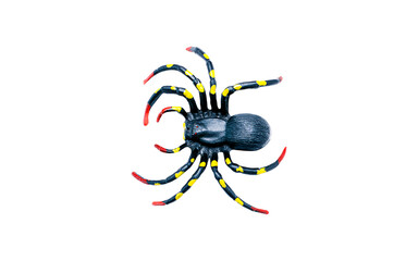 A plastic toy spider with a black body and legs marked with yellow dots and red tips. Isolated on a transparent background, perfect for Halloween, prank, or fear concepts. Top view