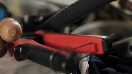 Leather crafting tools and wooden handles on artisan workbench - Powered by Adobe