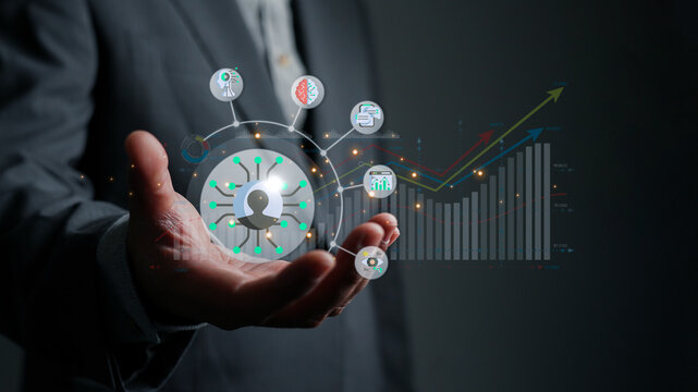 Businessman holding a business process automation hologram with a growth chart. Concept of strategy, data analysis, AI, and corporate development for future success.
