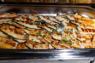 Grilled trout fish in a container to maintain the temperature
