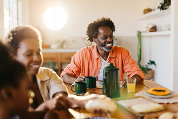Family sitting together for breakfast, feasting on a pão de queijo meal