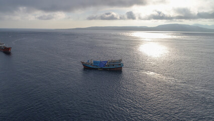 Naklejka premium Large fishing boats are seen anchoring at Banyuwangi harbor in the morning at sunrise