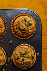 pumpkin muffins on an orange tablecloth