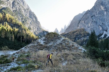 hiker with his dog in the mountains
