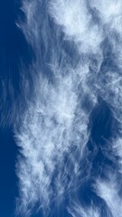 Wispy White Clouds on a Blue Sky Background