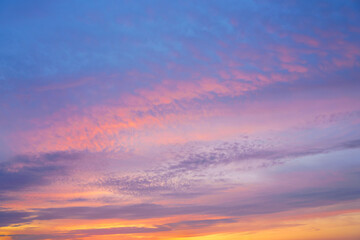 Beautiful sunset or sunrise sky with vibrant clouds changing from purple to orange is perfect for an abstract or nature background.