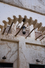 Close-up of carved wooden corbel and eave detail in Al Seef, highlighting craftsmanship and traditional architectural ornamentation.  © SVITLANA