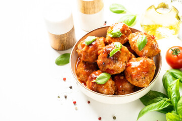 Meatballs in tomato sauce, glazed meatballs in craft plate on white table.