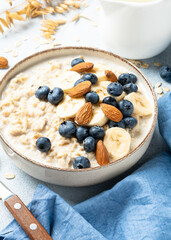 Oatmeal porridge with bananas, nuts and blueberries.