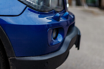Fototapeta premium Elegant Blue Car Details — Close-Up Artistic View of Modern Vehicle Surfaces, Reflections, and Design Elements Highlighting Automotive Aesthetics in Urban Environment