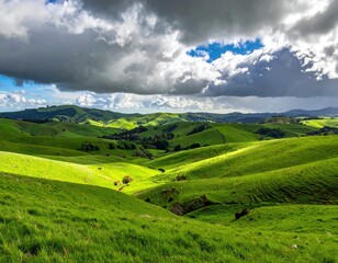 Fototapeta premium Vibrant Green Rolling Hills Under a Dramatic Cloudy Sky with Sunlight Breaking Through