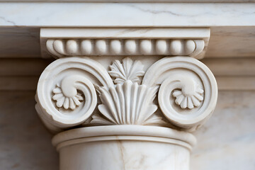 Naklejka premium Close-up of the decorative capital of a classical architectural column made of marble. Intricate carvings with floral and scroll motifs, smooth, shiny surface.