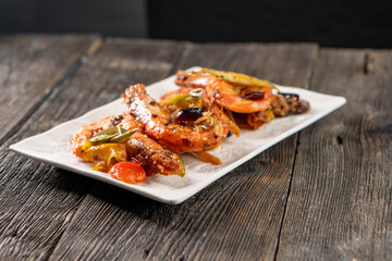 Frying shrimp with vegetables on a grill. Shrimp. Chinese cuisine. Asian food. Food concept.