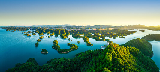 Beautiful lake with numerous green islands at sunrise in Zhejiang, China.