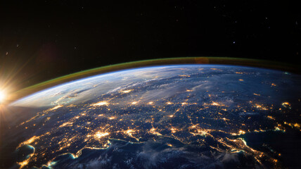 Fototapeta premium Earth from space at night with city lights and sunrise satellite