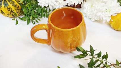 Autumn Composition with Pumpkin-Shaped Mug and Decorative Gourds