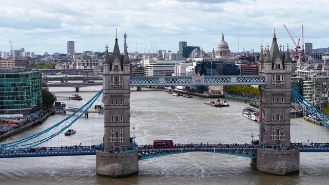 Cinematic aerial view of Tower Bridge (London Bridge) and the historic Tower of London with the stunning City of London skyline and its iconic modern architecture.