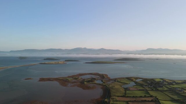 Breathtaking 4K aerial video of flying above scenic Atlantic Coast at Clew Bay with scenic coastline and islands at dawn, Murrisk, Westport, Mayo, Ireland