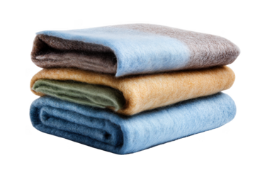 Stack of four folded soft textured blankets in muted colors isolated on a transparent background textile