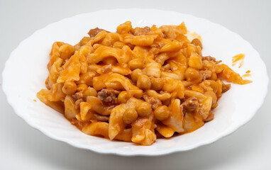 Pettole with chickpeas and meat is a traditional dish of southern cuisine, particularly from Campania, which combines the rusticity of pettole with the richness of a sauce based on chickpeas and meat.