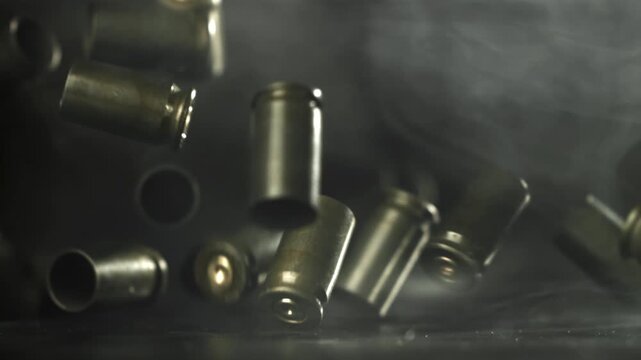 Bullet casings are pressed on the table. Filmed on a high-speed camera at 1000 fps. High quality FullHD footage