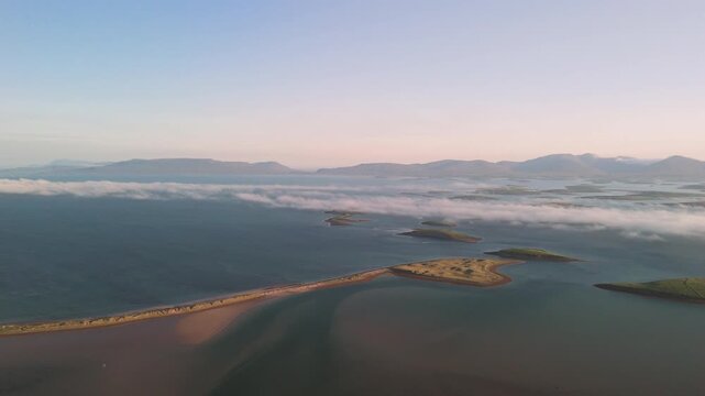 Breathtaking 4K aerial video of flying above scenic Atlantic Coast at Clew Bay with scenic coastline and islands at dawn, Murrisk, Westport, Mayo, Ireland