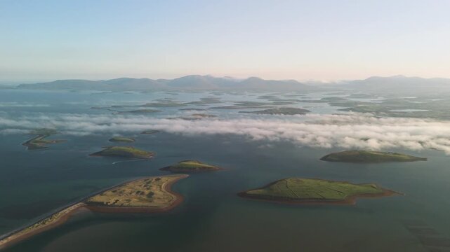 Breathtaking 4K aerial video of flying above scenic Atlantic Coast at Clew Bay with scenic coastline and islands at dawn, Murrisk, Westport, Mayo, Ireland