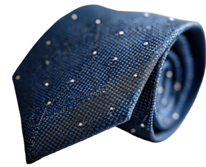 Blue woven tie with white dots, neatly rolled