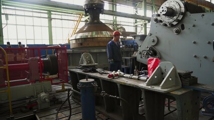 Engineer supervising machinery operation in industrial plant. Stock clip