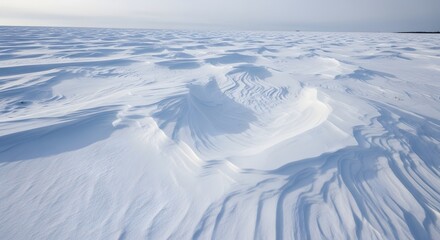 Fototapeta premium Abstract patterns of windsculpted snowdrifts in a vast expanse