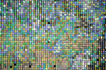 Colorful mosaic pattern created by small tiles reflecting light in varying shades and hues