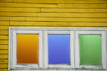 Colorful Glass Windows in Yellow Wooden Wall Structure