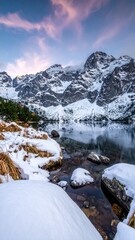 Snow-covered mountain lake at dawn