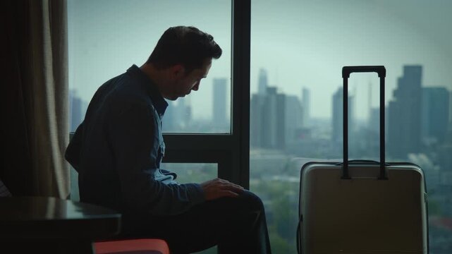 A traveler is relaxing in a hotel room that offers a stunning view of the cityscape