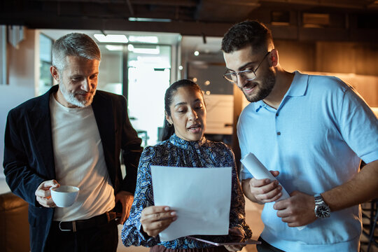 Group of business people reviewing documents in a office