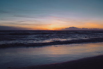 Ocean waves under a colorful twilight sky after sunset. The scene captures peaceful motion and subtle light, symbolizing balance, mindfulness, and the timeless rhythm of nature