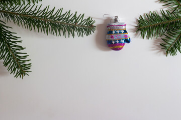 Christmas decorations with mitten and fir tree branches on white background. Copy space.