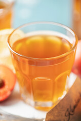 Refreshing apricot kombucha tea in a glass. Healthy drink