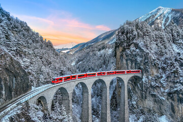 Aerial view of Train passing through famous mountain in Filisur, Switzerland. Landwasser Viaduct...