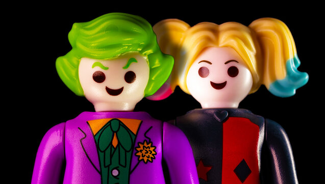 The Joker and Harley Quinn standing on a black background